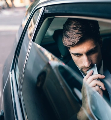Professional Chauffeur Opening Door for VIP Client
